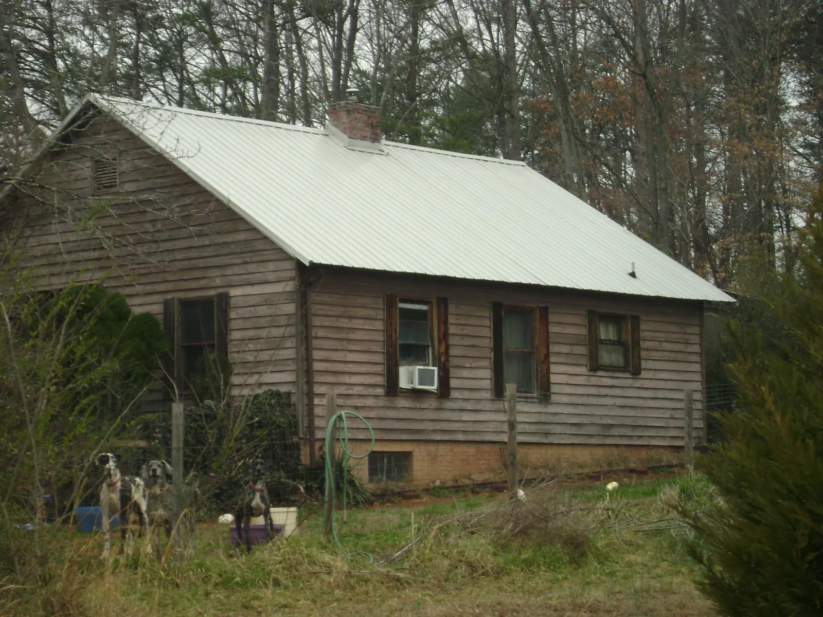 White metal roof on an old wood sided farmhouse, from a Metal Roof Installation job in Manteca